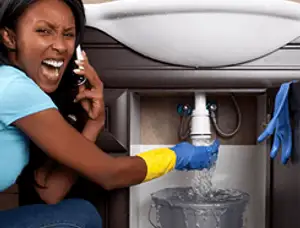 Emergency plumbing repair for a leaking sink drain under a bathroom vanity in Loveland, CO
